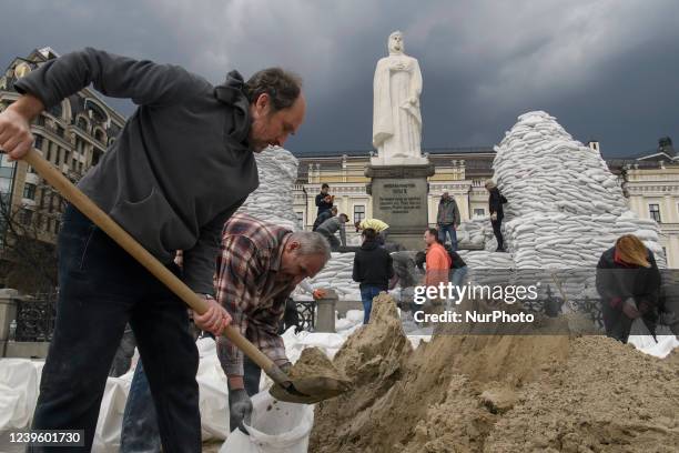 Volunteers cover a monument of the Princess Olga, Apostle Andrew, Cyril and Methodius of sand bags for protection as Russia's invasion of Ukraine...