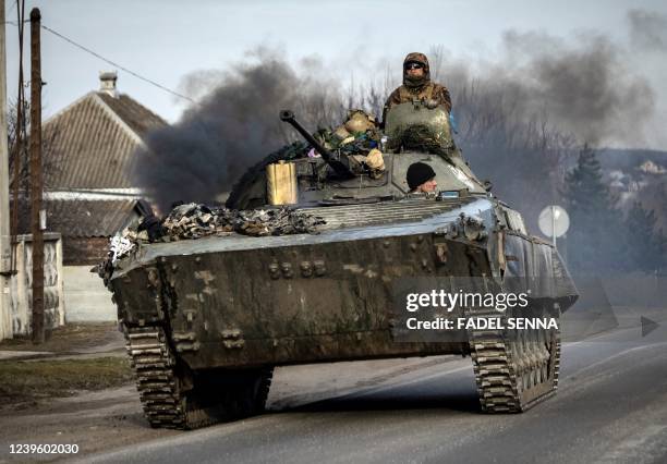 Ukrainian tank steers his way on a road in the northeastern city of Trostyanets, on March 29, 2022. - Ukraine said on March 26, 2022 its forces had...