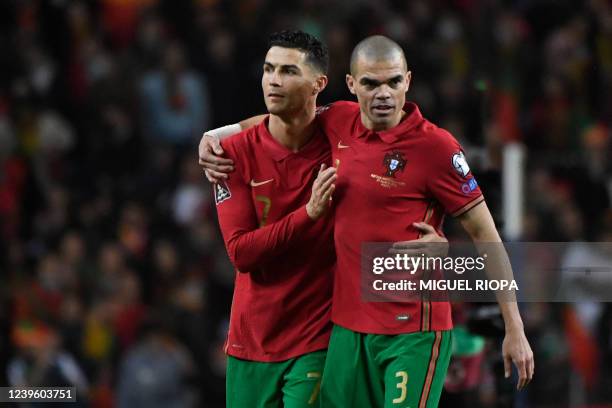 Portugal's forward Cristiano Ronaldo and Portugal's defender Pepe celebrate at the end of the World Cup 2022 qualifying final first leg football...