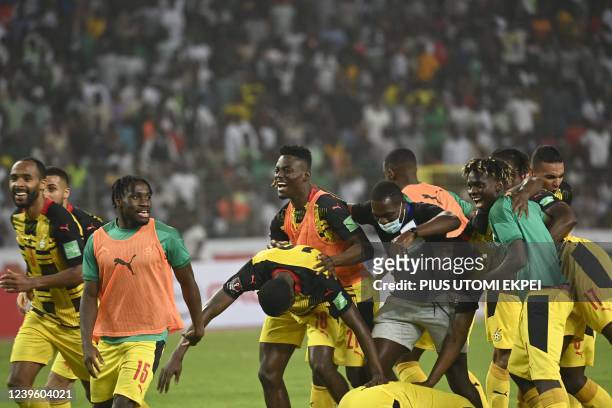 Ghana players celebrate their victory during the World Cup 2022 qualifying football match between Nigeria and Ghana at the National Stadium in Abuja...