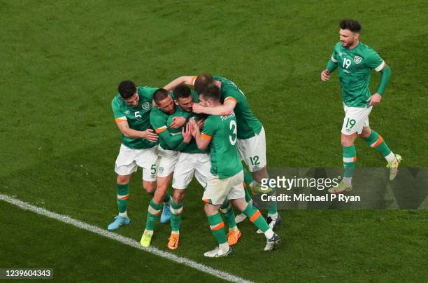 Dublin , Ireland - 29 March 2022; Troy Parrott of Republic of Ireland, centre, celebrates with teammates after scoring their side's winning goal...