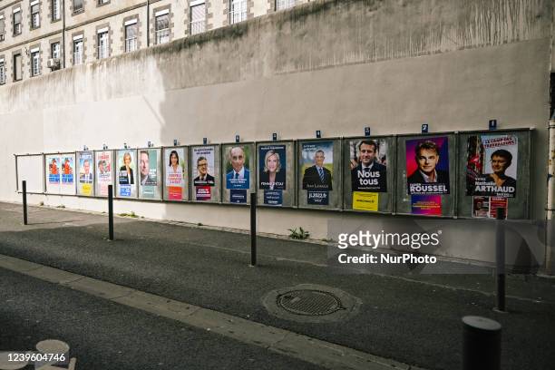 Political campaign posters of candidates for the incoming election are glued in different places of the city of Clermont-Ferrand, on billboards, on...