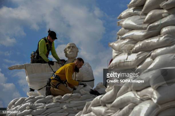 Ukrainian volunteers seen piling sandbags to protect the monument to Princess Olga, the Holy Apostle Andrew the First-Called and Enlighteners Cyril...