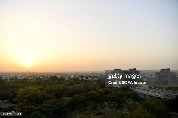 View of an Indian Railways passenger train during sunset at Nehru Place in Delhi. New Delhi in India is an administrative district of the National...
