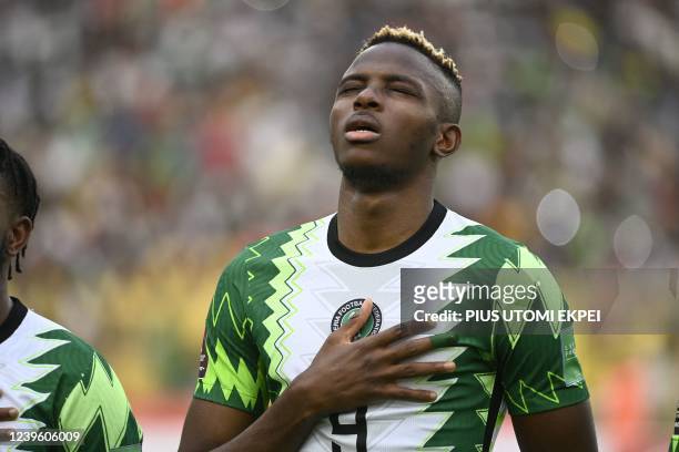 Nigeria's Victor Osimhen sings Nigeria's national anthem during the World Cup 2022 qualifying football match between Nigeria and Ghana at the...