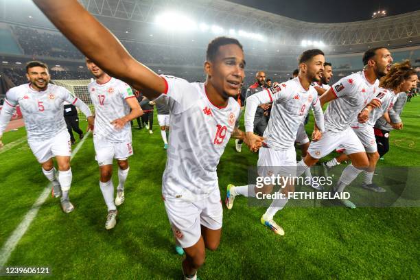 Tunisia's players celebrate qualifying to the 2022 Qatar World Cup African Qualifiers football match between Tunisia and Mali at the Hamadi Agrebi...