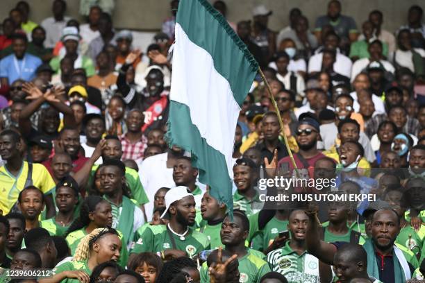 Nigerian fans cheer during the World Cup 2022 qualifying football match between Nigeria and Ghana at the National Stadium in Abuja on March 29, 2022.