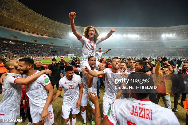 Tunisia's players celebrate qualifying to the 2022 Qatar World Cup African Qualifiers football match between Tunisia and Mali at the Hamadi Agrebi...