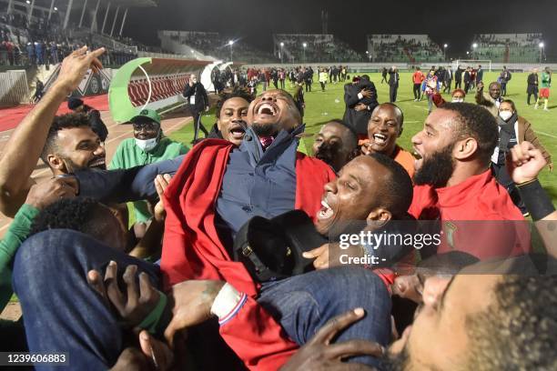 Cameroon's players celebrate with Samuel Eto'o, president of the Cameroonian Football Federation, after qualifying for the 2022 Qatar World Cup in...