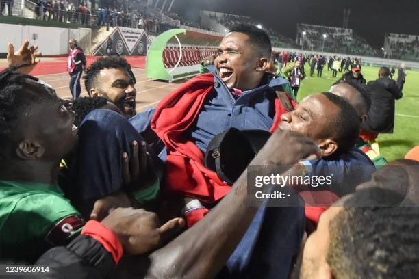 Cameroon's players celebrate with Samuel Eto'o, president of the Cameroonian Football Federation, after qualifying for the 2022 Qatar World Cup in...
