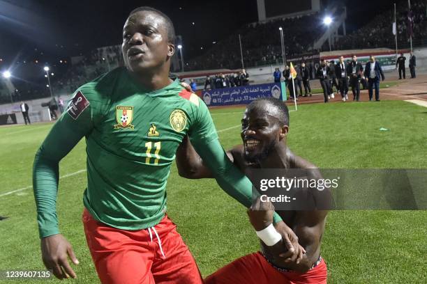 Cameroon's defender Nouhou Tolo celebrates with teammate after qualifying for the 2022 Qatar World Cup African Qualifiers football match between...