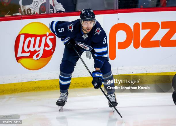 Brenden Dillon of the Winnipeg Jets prepares for a third period face-off against the Ottawa Senators at Canada Life Centre on March 24, 2022 in...