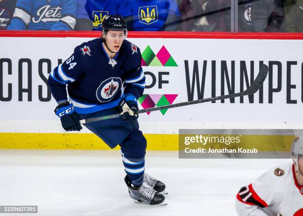 Logan Stanley of the Winnipeg Jets keeps an eye on the play during third period action against the Ottawa Senators at Canada Life Centre on March 24,...