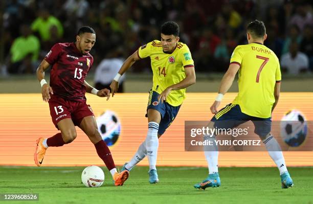 Venezuela's Jose Martinez vie for the ball with Colombia's Luis Diaz and Colombia's Rafael Santos Borre during their South American qualification...