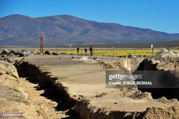 Chilean soldiers stand guard at the Chile-Bolivia border, near Pisiga, on March 24, 2022. - Hundreds of Venezuelan migrants illegally cross, on foot,...