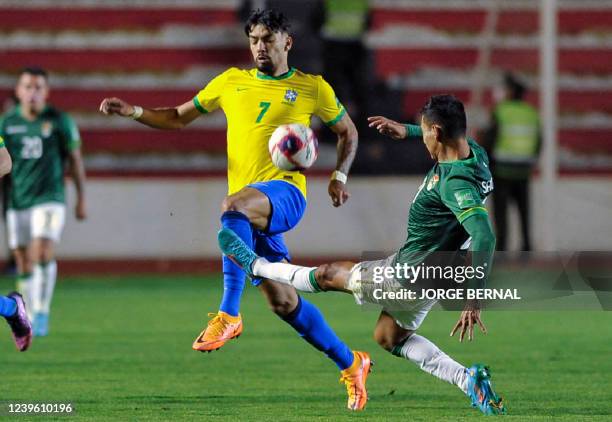 Brazil's Lucas Paqueta and Bolivia's Jose Sagredo vie for the ball during their South American qualification football match for the FIFA World Cup...