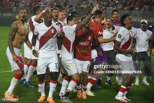 Peruvian players celebrate after defeating Paraguay in their South American qualification football match for the FIFA World Cup Qatar 2022 at the...