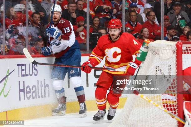 Rasmus Andersson of the Calgary Flames battles against Valeri Nichushkin of the Colorado Avalanche at Scotiabank Saddledome on March 29, 2022 in...