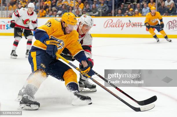 Matt Duchene of the Nashville Predators skates the puck in on net against Nick Holden of the Ottawa Senators during an NHL game at Bridgestone Arena...