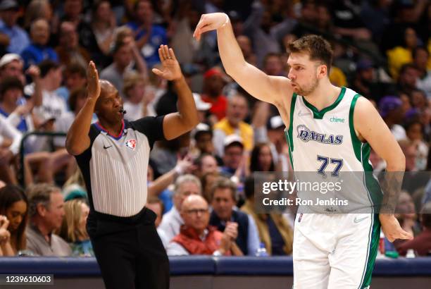 Luka Doncic of the Dallas Mavericks celebrates a three point basket as referee Marc Davis signals against the Los Angeles Lakers in the second half...