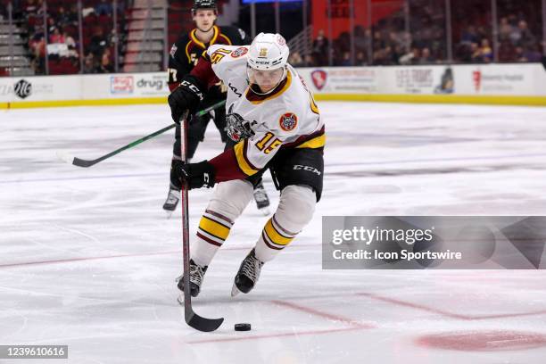 Chicago Wolves center Jack Drury plays the puck during the third period of the American Hockey League game between the Chicago Wolves and Cleveland...