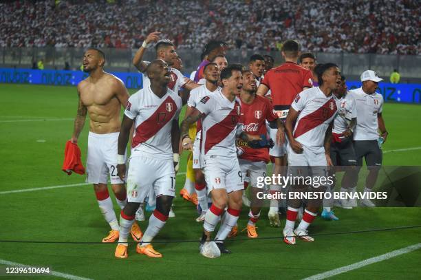 Peruvian players celebrate after defeating Paraguay in their South American qualification football match for the FIFA World Cup Qatar 2022 at the...