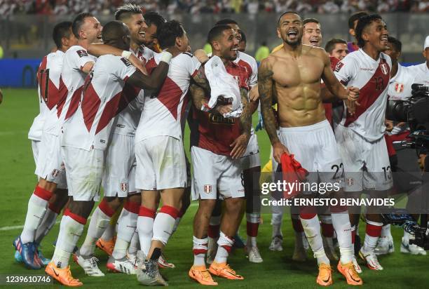 Peruvian players celebrate after defeating Paraguay in their South American qualification football match for the FIFA World Cup Qatar 2022 at the...