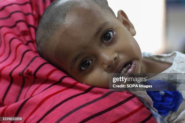 Mother carries her baby suffering from diarrhoea in a hospital. Diarrhoea patients are increasing at the International Centre for Diarrhoea Diseases...