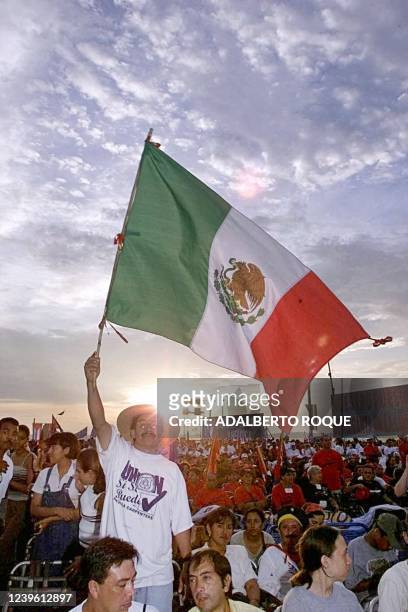 Mexican citizen waves his national flag 03 August during a celebration of the anniversary of Castro's attack on the Moncada barracks in...