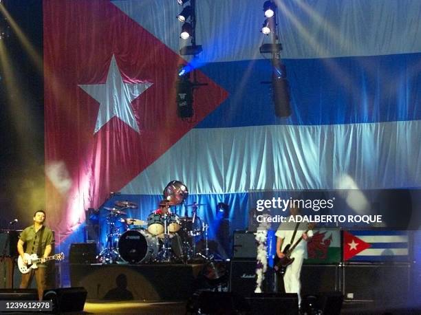 The British rock band Manic Street Preachers performs on the stage of the Karl Marx Theater in Havana 17 February, 2001 with the Cuban flag as a...