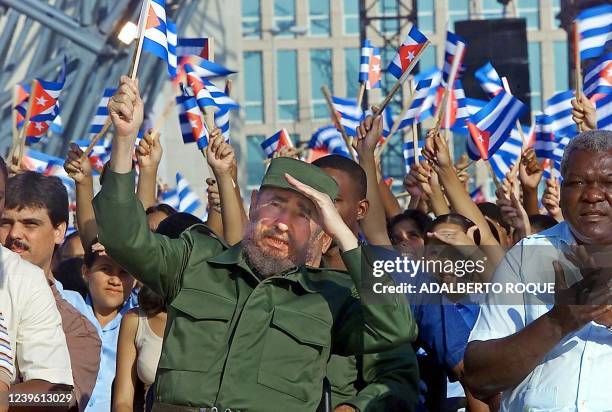 Cuban President Fidel Castro waves a flag 19 May 2000 in Havana, during a ceremony inaugurating a statue of national hero Jose Marti. Castro also...