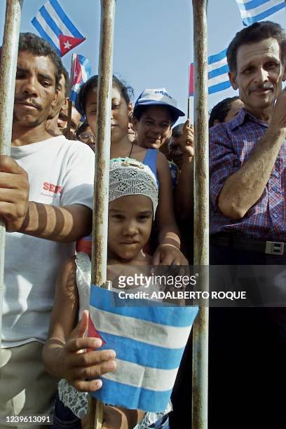 Girl holds a Cuban flag when she attends a political rally in Manzanillo 01 July, 2000 where some 300,000 people demonstrated against the continuing...