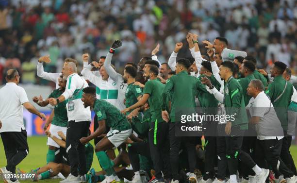 Saudi Arabia's team celebrate after beating Australia 1-0 in their 2022 Qatar World Cup Asian Qualifying match at the King Abdullah Sport City...