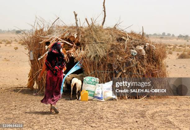 Poor Yemeni families receive flour rations and other basic food supplies like rice, oil and sugar, from charities in the province of Lahj, in...