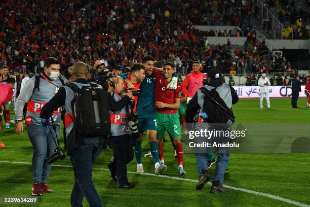 Players of Morocco celebrate their victory at the end of the FIFA World Cup African Qualifiers 3rd round match between Morocco and Democratic...