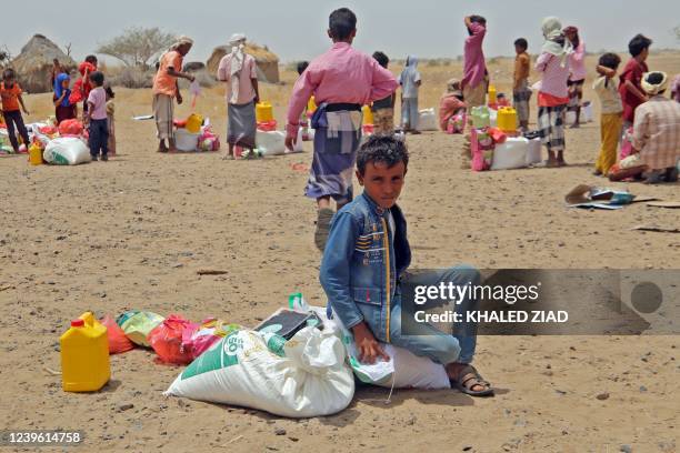 Yemenis displaced by the conflict, receive food aid and supplies to meet their basic needs, at a camp in Hays district in the war-ravaged western...