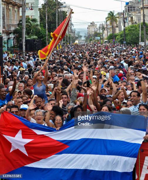 Cubans celebrate with a national flag the 49th anniversary of the declaration of the socialist character of the Revolution by its leader Fidel Castro...