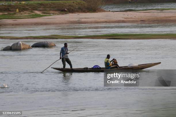 Boatman crosses the Niger River as daily life continues in Niamey, Niger on March 28, 2022. The Niger River, the largest river in West Africa, is...