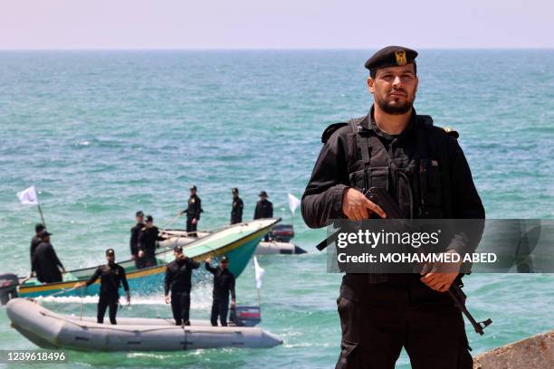 Palestinian policemen keep watch during a rally marking the 46th anniversary of Land Day, at the port in Gaza City on March 30, 2022. - Land Day...