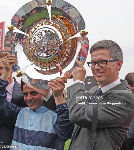 Italian jockey Andrea Atzeni and trainer Roger Charlton with the trophy for winning the St Leger with Kingston Hill at Doncaster, 13th September 2014.