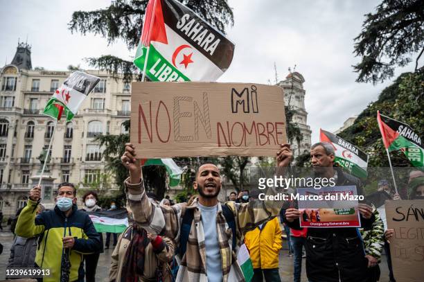 Man holds a placard reading 'not in my name' as Saharawi community and supporters hold a demonstration in front of the Congress of Deputies where...