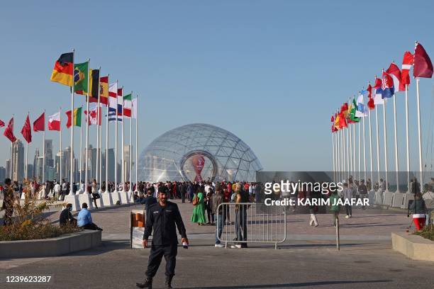 People gather during a flag-raising ceremony of the newly-qualified countries for the 2022 World Cup in the Qatari capital Doha, on March 30, 2022. -...