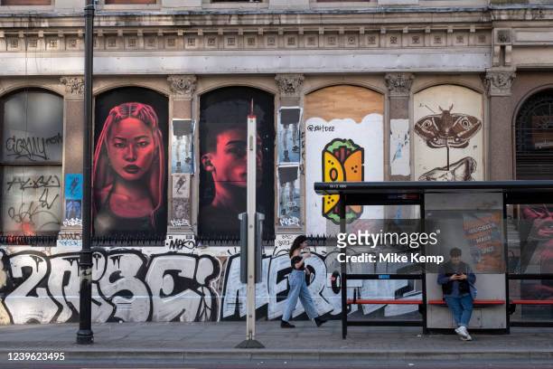 Street art at the bus stop in Shoreditch on 24th March 2022 in London, United Kingdom. Shoreditch is a fashionable area adjacent to the equally hip...