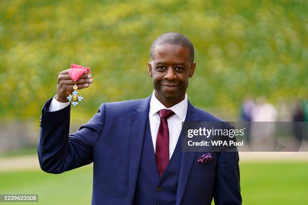 Adrian Lester CBE poses after being presented his honours by the Princess Royal during an investiture ceremony at Windsor Castle on March 30, 2022 in...