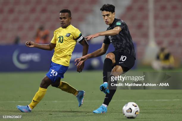 Marko Stamenic of New Zealand and Micah Lea'alafa of Solomon Islands during the 2022 FIFA World Cup Oceania Qualifier Final match between Solomon...