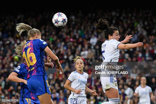 Barcelona's Swedish forward Fridolina Rolfo and Real Madrid's Spanish defender Ivana Andres jump for the ball during the women's UEFA Champions...