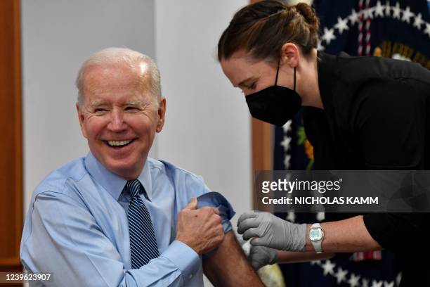 President Joe Biden receives a second booster shot of the Pfizer Covid-19 vaccine in the South Court Auditorium, next to the White House, in...