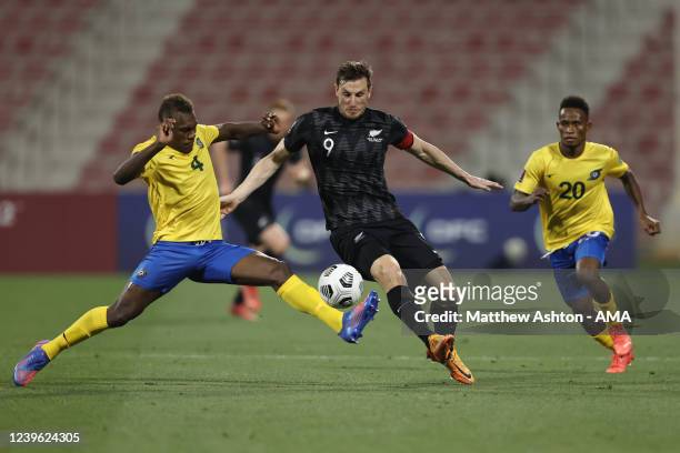 Leon Kofana of Solomon Islands tackles Chris Wood of New Zealand during the 2022 FIFA World Cup Oceania Qualifier Final match between Solomon Islands...