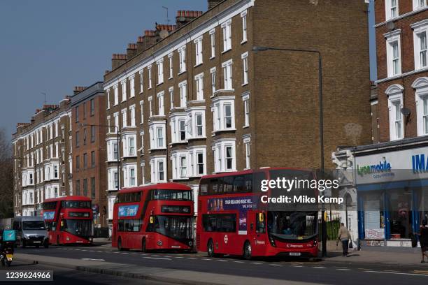 Buses on the Old Kent Road on 24th March 2022 in London, United Kingdom. Old Kent Road is a major thoroughfare in South East London passing through...