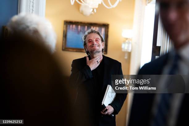 Bono, U2 lead singer and co-founder of The ONE Campaign, is seen in the U.S. Capitol office of Sen. John Thune, R-S.D., right, on Wednesday, March...